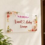 Personalized floral couple name plate on a cream wall - Vineet and Ruby with house number B-288