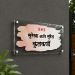 Personalized Hindi name plate on a grey exterior wall near the gate - Kulkarni Marathi watercolour acrylic