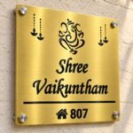 Customised name plate for home in golden brushed stainless steel, 12 by 12 inches, angled product view