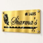 Metal name plate for home in golden brushed stainless steel, 6 by 12 inches, angled product view