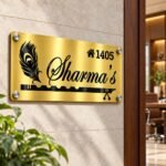 Metal name plate for home in golden brushed stainless steel, 6 by 12 inches, installed entrance view