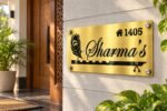 Metal name plate for home in golden brushed stainless steel, 6 by 12 inches, installed entrance view
