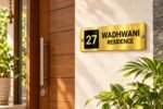 Name plate for office in golden brushed stainless steel, 4 by 12 inches, installed entrance view