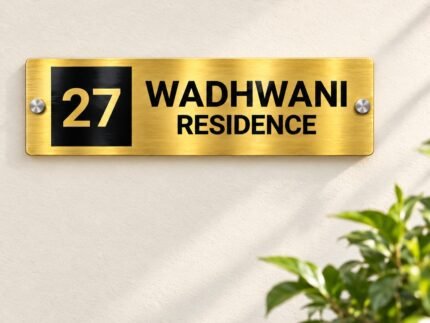 Name plate for office in golden brushed stainless steel, 4 by 12 inches, installed entrance view